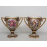 A pair of Vienna small two handled pedestal Cups painted mythological scenes in oval panels and with