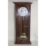 A walnut cased Vienna Regulator Timepiece with circular dial marked with Roman numerals and with