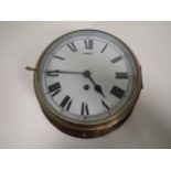 A brass cased circular Railway Clock with white enamel dial, having single train movement, 10in diam