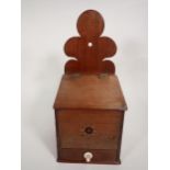 A 19th Century mahogany Candle Box with shaped surmount, sloping lid and drawer under, star inlay,