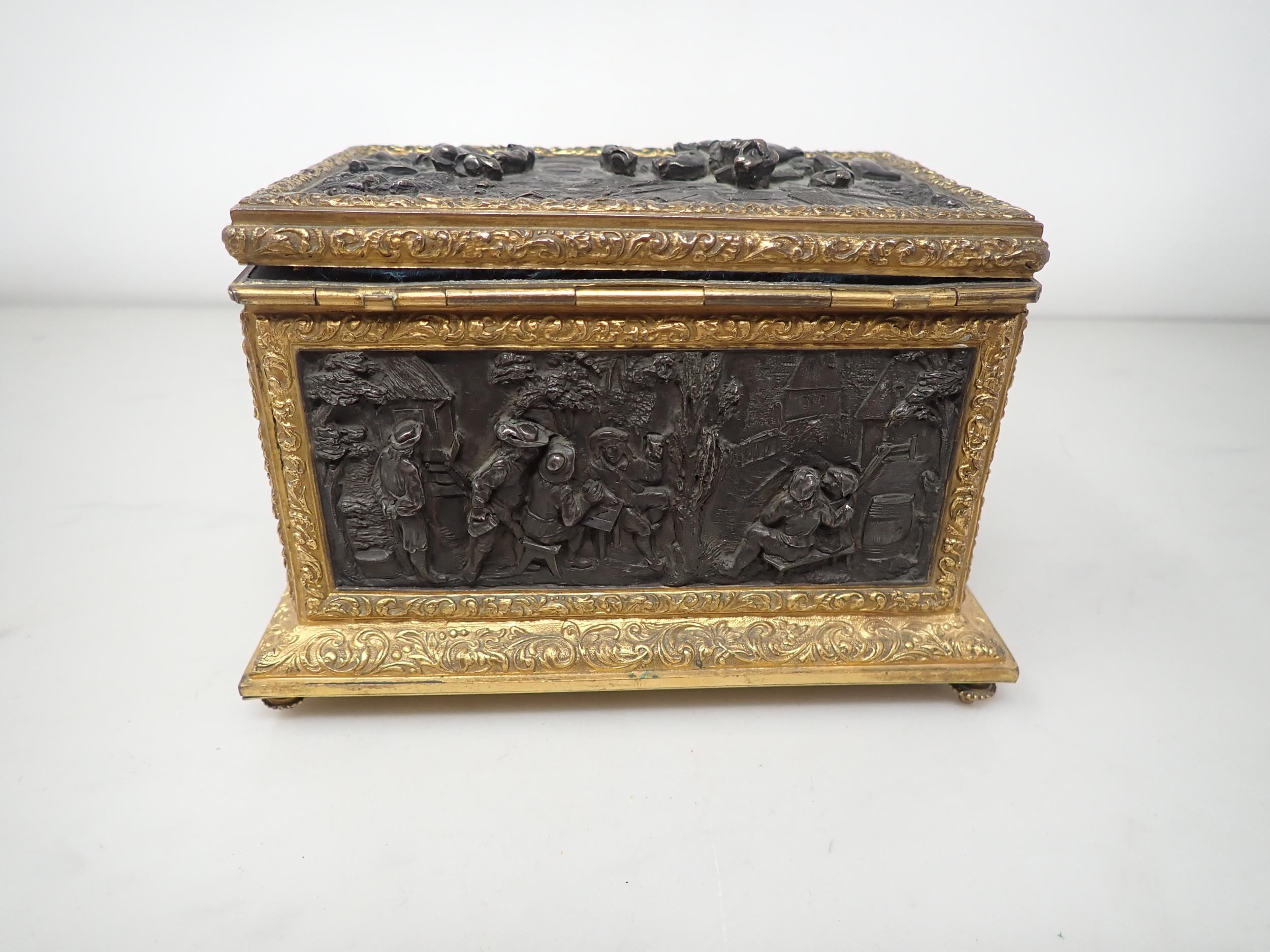 A 19th Century French gilt-metal and bronzed Casket, the inset panels decorated figures merrymaking, - Image 5 of 6