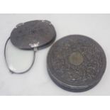 A 19th Century pressed tortoiseshell oval Magnifying Glass with floral carved decoration and white