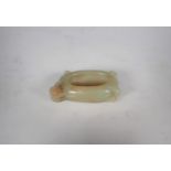 A Chinese Jade Brush Washer of oval form carved flower and leaves, approx 3in wide