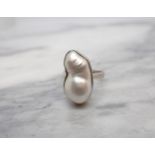 A contemporary Baroque Pearl Ring collet-set single pearl in white gold stamped 585, ring size K/L