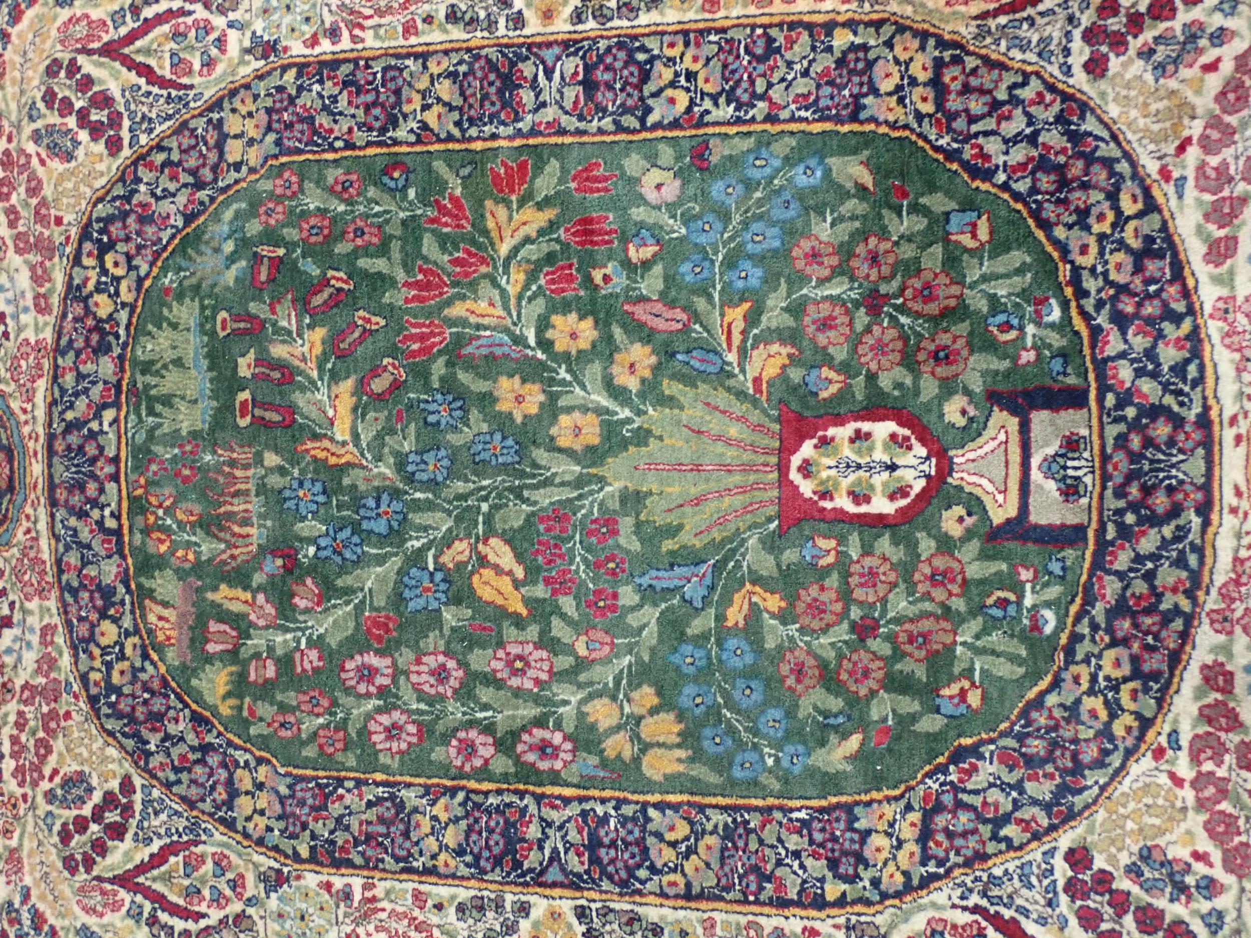 A fine quality Persian Rug with floral designs two the borders, and central oval depicting vase of - Image 2 of 6