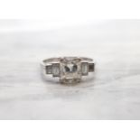 A Diamond Ring corner claw-set asscher-cut stone, estimated 1.20ct, between two pairs of baguettes