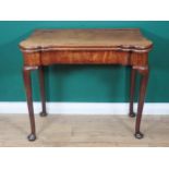 A Georgian mahogany Card Table with shaped fold-over top enclosing baize lining and counter wells,