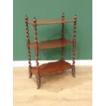 A 19th Century mahogany serpentine three tier Etergere with spiral turned supports and casters,
