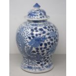 A Chinese blue and white Jar and Cover of baluster form decorated dragons amongst flowers, 15in H,