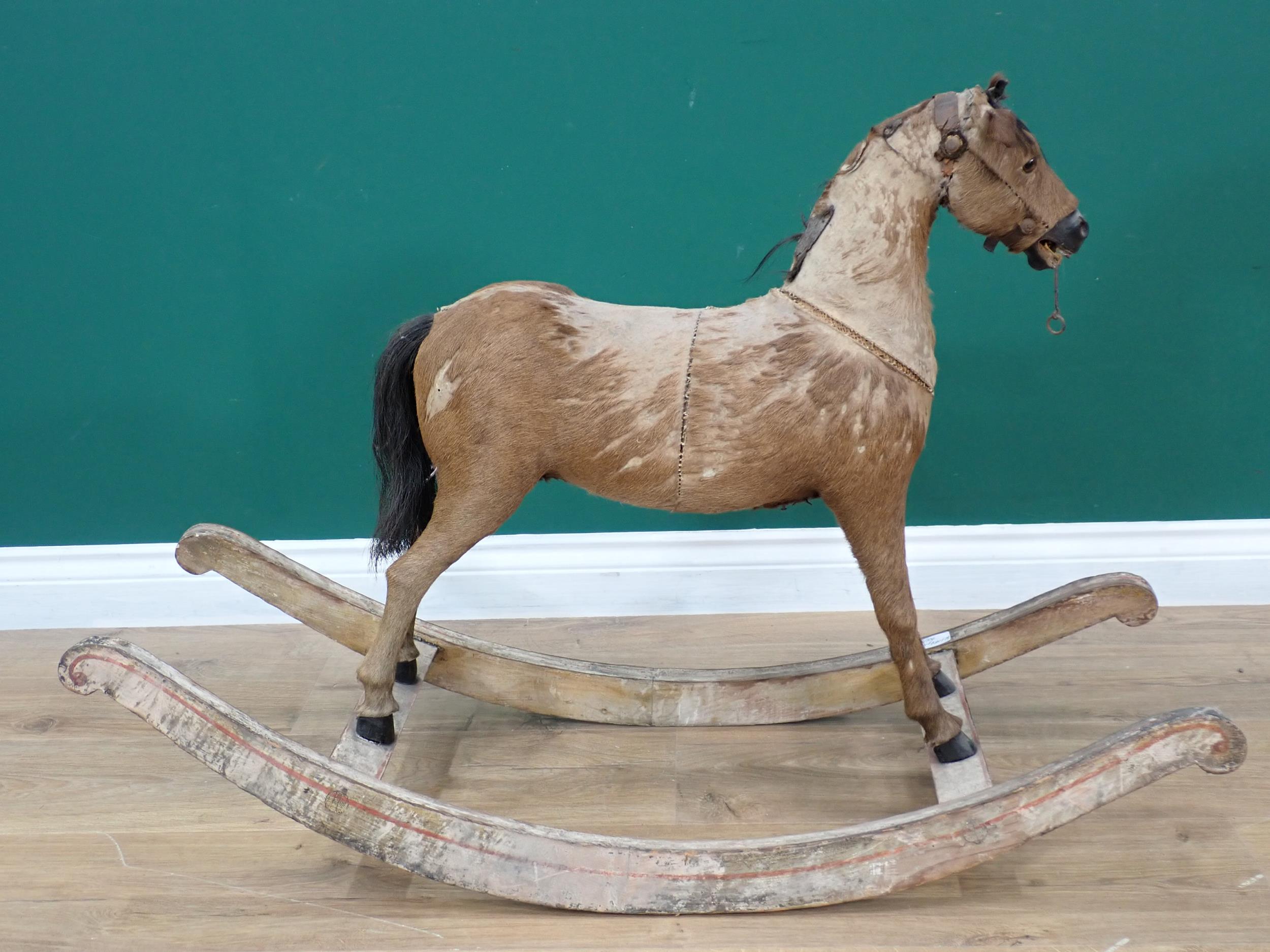 An antique fur covered Rocking Horse on white painted rockers 3ft 2in L x 2ft 2in H