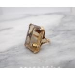 A large Citrine Dress Ring corner claw-set emerald-cut stone in pierced mount, unmarked, untested,