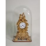 A 19th Century French gilded metal Mantel Clock by Le Roy & Fils with white enamel dial surmounted