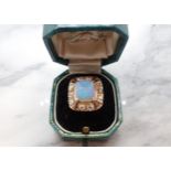 An Opal, Diamond and Enamel Ring corner claw-set rectangular opal cabochon within a frame of ten