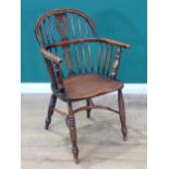 A 19th Century ash Windsor Elbow Chair mounted upon turned supports united by crinoline stretcher