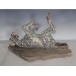 PIERRE DIAMANTOPOULO. A stoneware Model of a Zebra lying on its back, and mounted on a stone plinth,