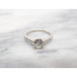 A Diamond single stone Ring claw-set brilliant-cut stone, 1ct, between graduated brilliant-cut