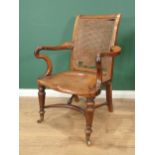 An early 19th Century mahogany Bergere Library Chair with cane panelled back (A/F), shepherd crook