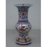 A Chinese Doucai Vase with flared rim, tapering to the neck with bulbous body and spreading foot,
