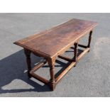 An antique oak Refectory Table in the 17th Century style with moulded top above a shaped and channel