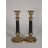 A pair of Georgian style mahogany Candlesticks with brass holders on reeded column and circular