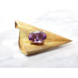 A contemporary Amethyst Brooch claw-set single oval-cut stone, unmarked untested, 6cms long,