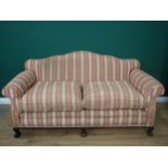 A Georgian style camel back Sofa with red and gold striped upholstery mounted upon three claw and