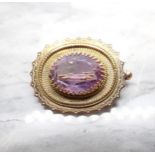 An Amethyst Brooch claw-set oval-cut stone within beaded and scalloped frame in 9ct gold, approx