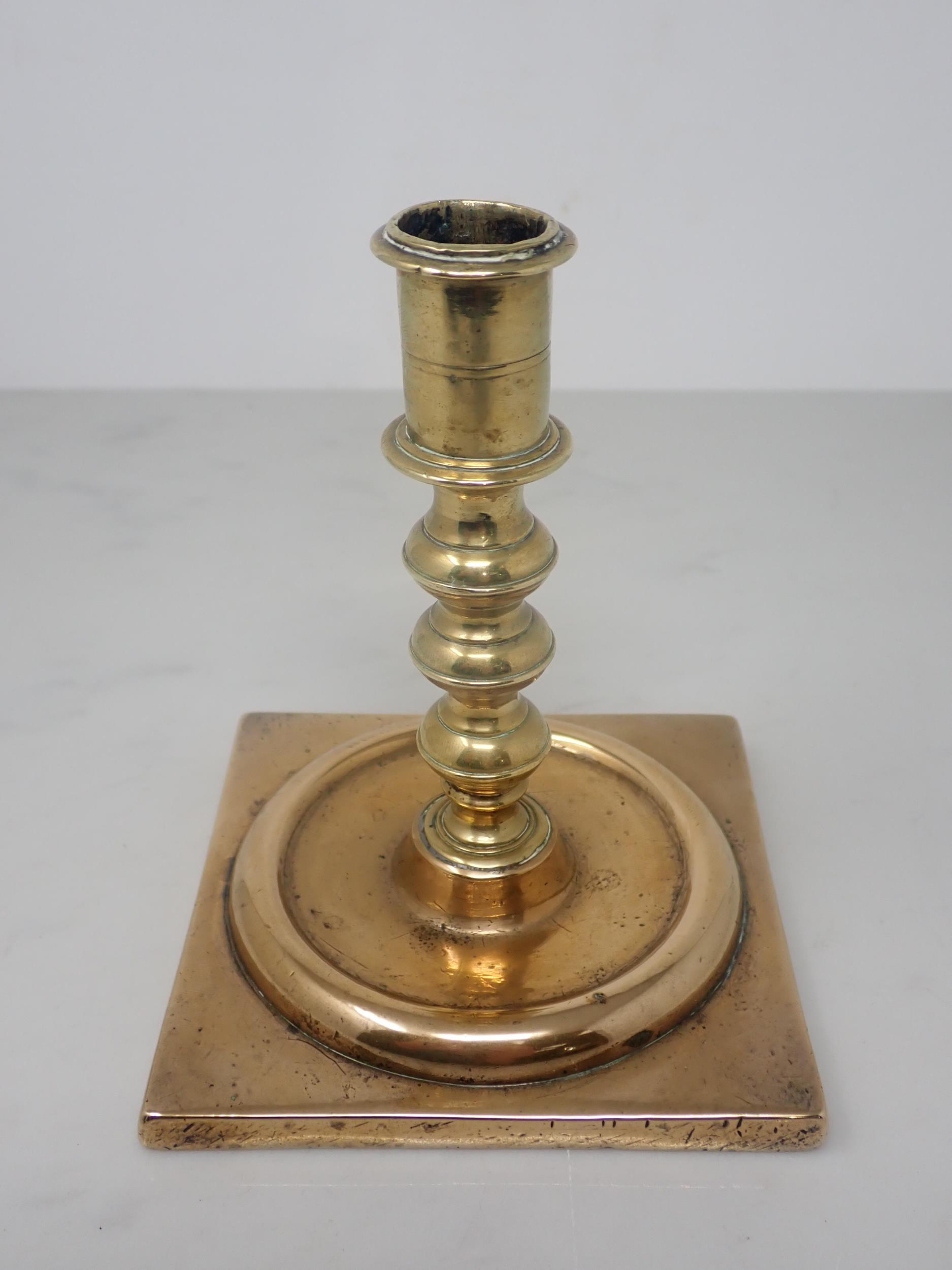 A Georgian brass Candlestick with knopped stem and square base, 5½in H