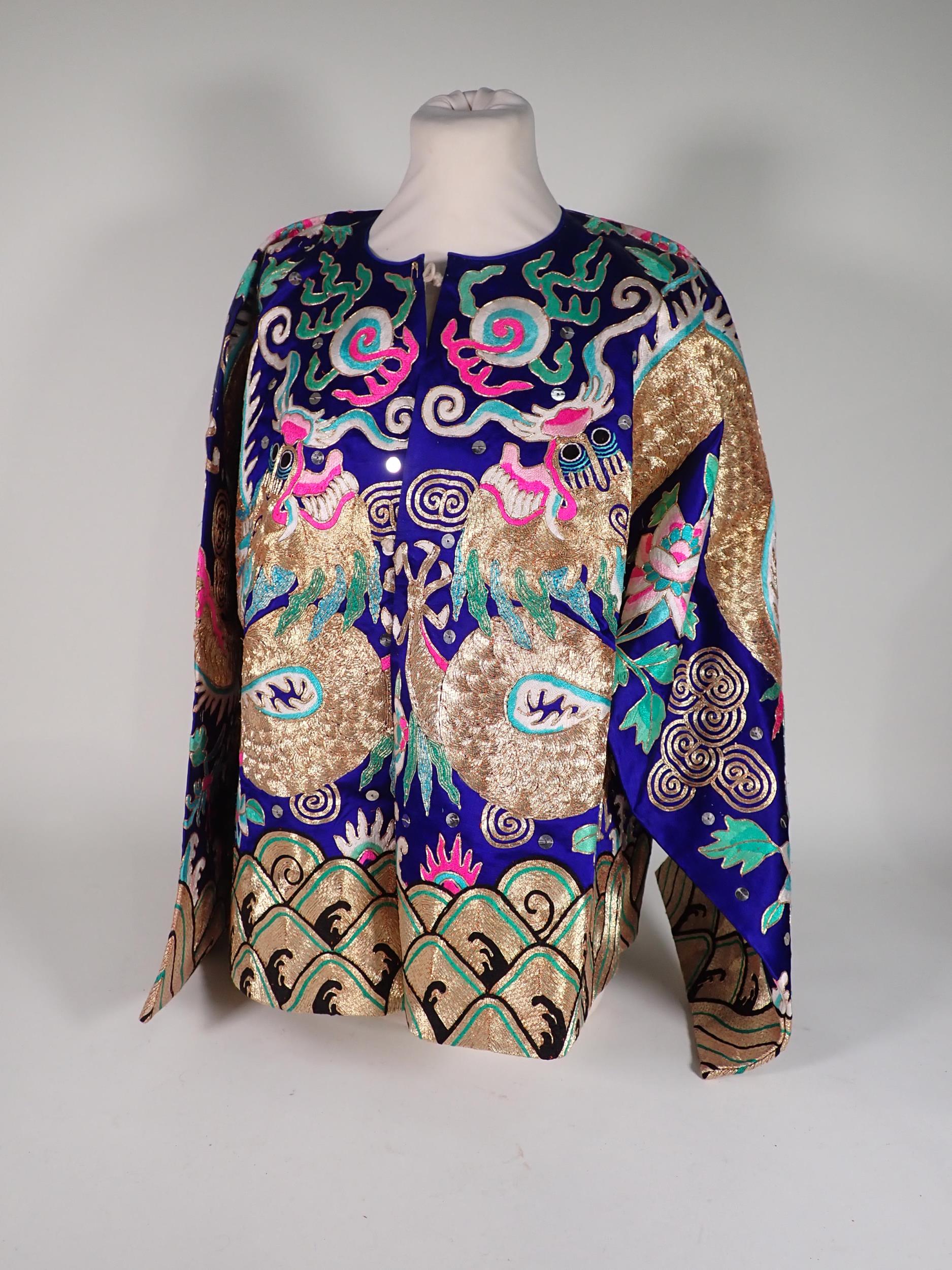 A late 19th/early 20th Century Chinese blue silk Jacket, embroidered gold and polychrome dragon,