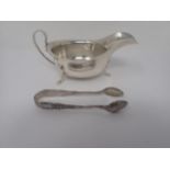 A George V silver Sauce Boat, Sheffield 1933, and a pair of silver Sugar Tongs, Birmingham 1900