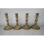 A set of four antique brass Candlesticks with baluster columns on octagonal bases, 6in