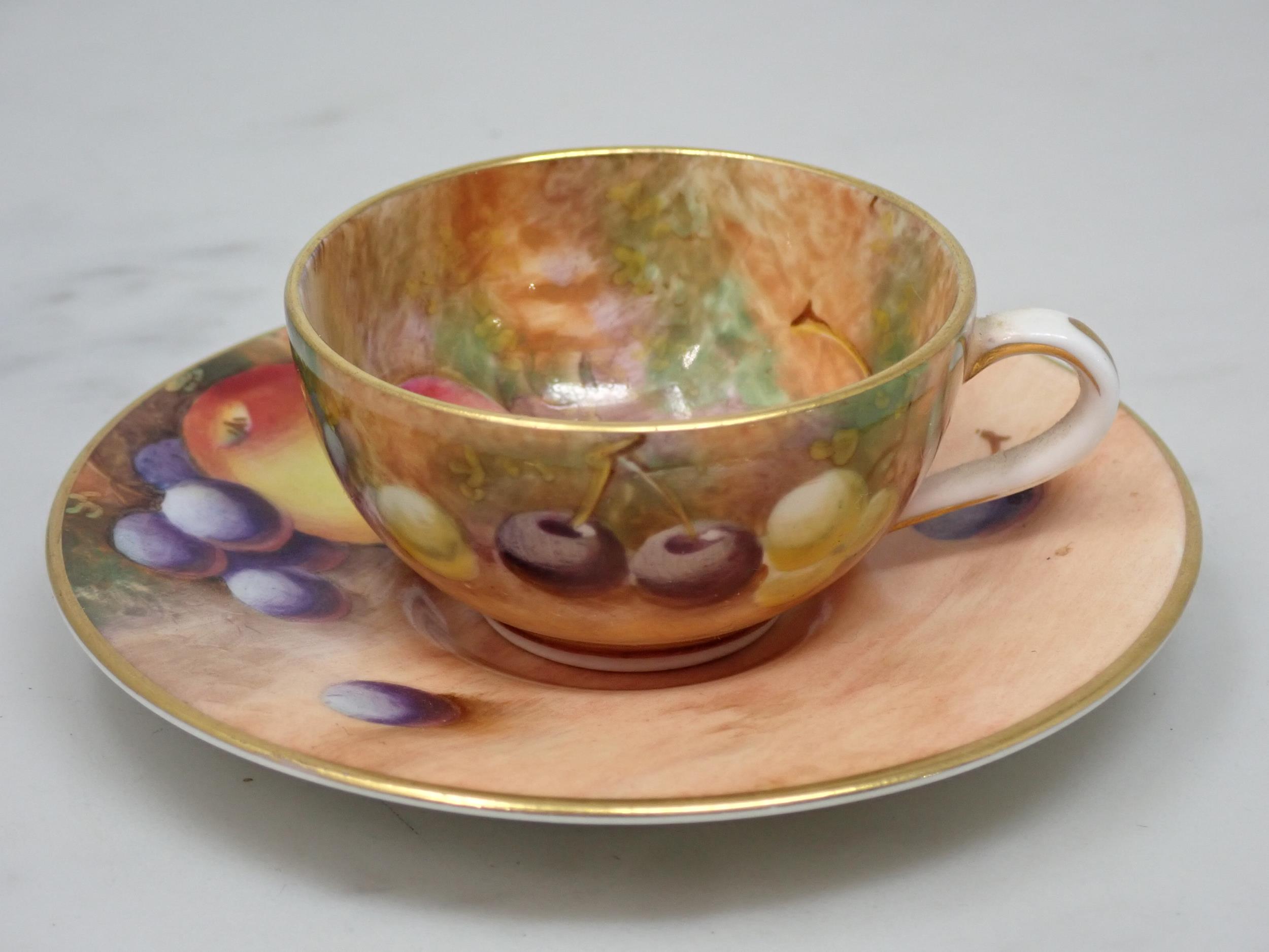 A Royal Worcester miniature Cup and Saucer painted still life of fruit, signed