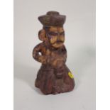 A Folk Art Carving of a figure with remnants of yellow and red paint, 10in H