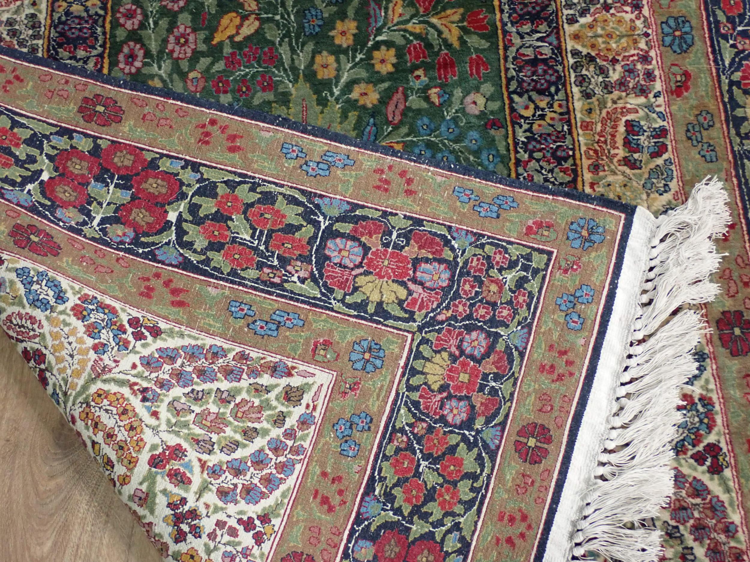 A fine quality Persian Rug with floral designs two the borders, and central oval depicting vase of - Image 4 of 6