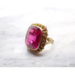 A synthetic Ruby Ring millegrain-set large cushion-cut stone in cannetille frame, stamped 585,