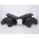 A pair of model Corronades of good form on wooden carriages, barrels 8 1/2in