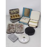 An Army & Navy japanned Fly Tin containing a quantity of trout Flies, a japanned Rig Tin, another