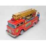 A boxed Japanese F-6 friction powered Fire Engine, a boxed Schuco 1227 Ford Coupe T and boxed