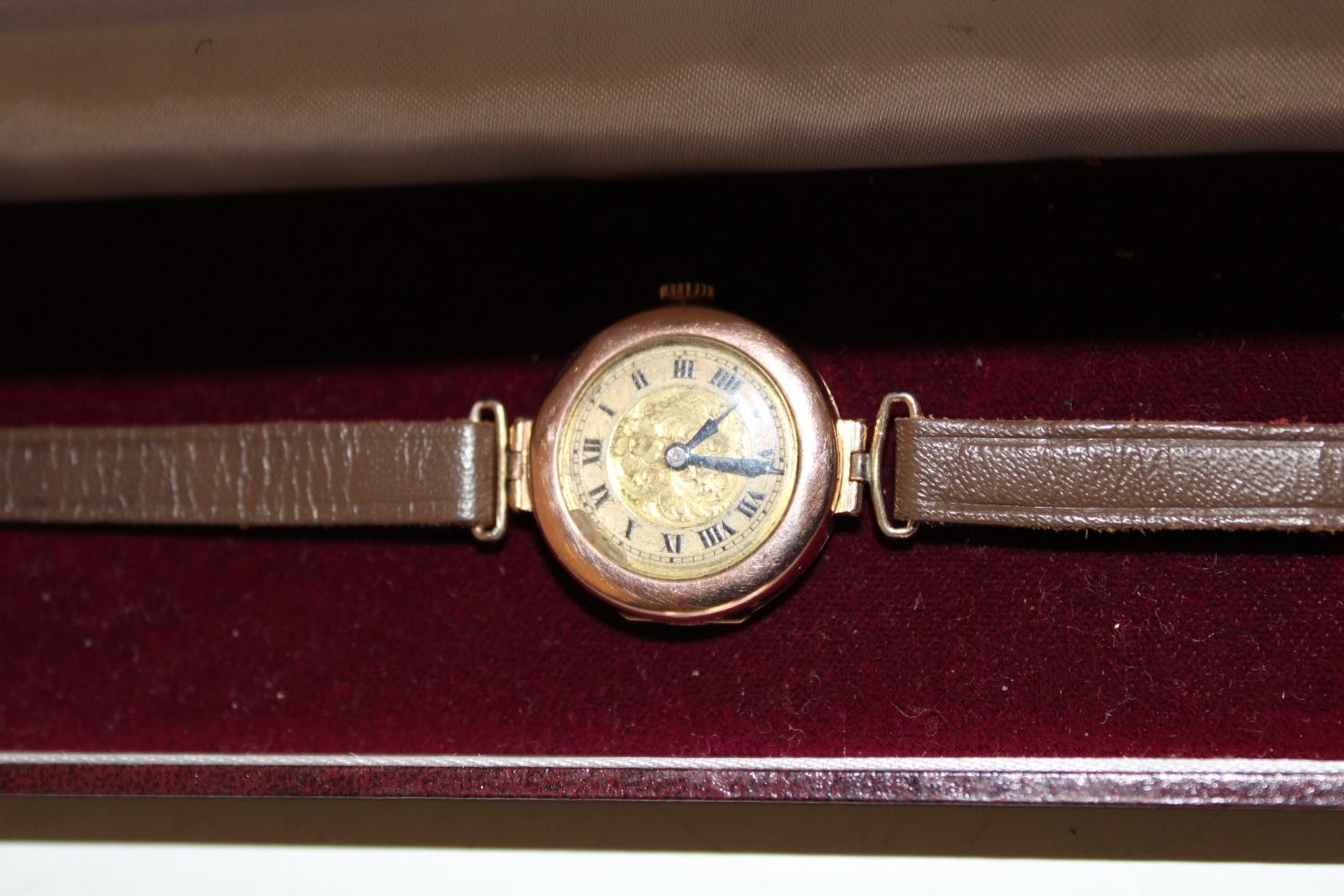 A vintage Ladies 9ct gold bodied watch with unusual hinged opening to the back