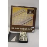 A glass chess set & set of dominoes