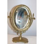 A Art Deco period brass & glass swivel mirror 26cm tall