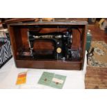 A vintage Singer electric sewing machine (missing foot pedal)
