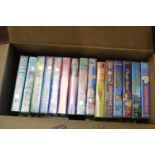 A box of assorted VHS tapes mainly Disney