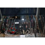 A shelf full of silver & gold tone jewellery