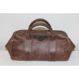 A vintage leather Gladstone bag