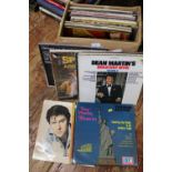 A box of mixed genre LP records