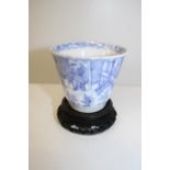 A antique Chinese tea bowl with six character mark to the base, on a wooden stand 6.5cm tall x 7.5cm