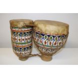 A set of ceramic & animal hide bongo drums 25cm tall