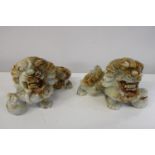 A pair of hand carved hard stone Chinese Foo Dogs. (Some damage) 26cm x 17cm