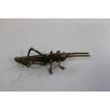An unusual brass Cricket. 11cm long